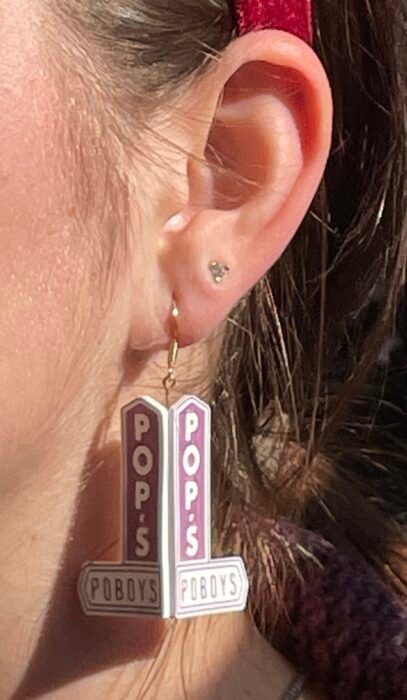 Business sign reproduced as an earring