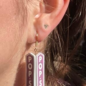 Business sign reproduced as an earring