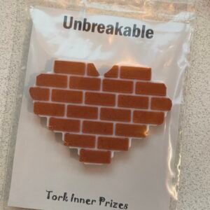 Pin of a heart shaped section of brick wall