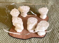 The Select Committee Heads of six men are cut off mid-brain to let the flat tops serve as supports for a tiny modernist coffee table.