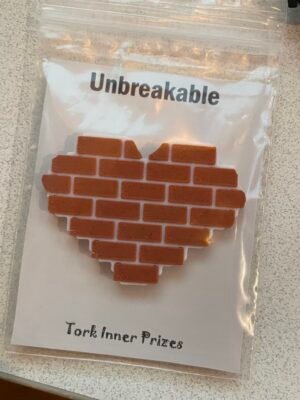 Pin of a heart shaped section of brick wall
